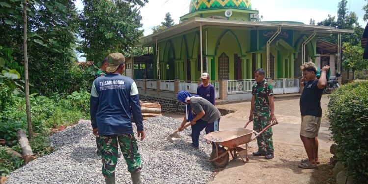 Semangat Gotong Royong Babinsa Bersama warga Melangsir Material Bangunan